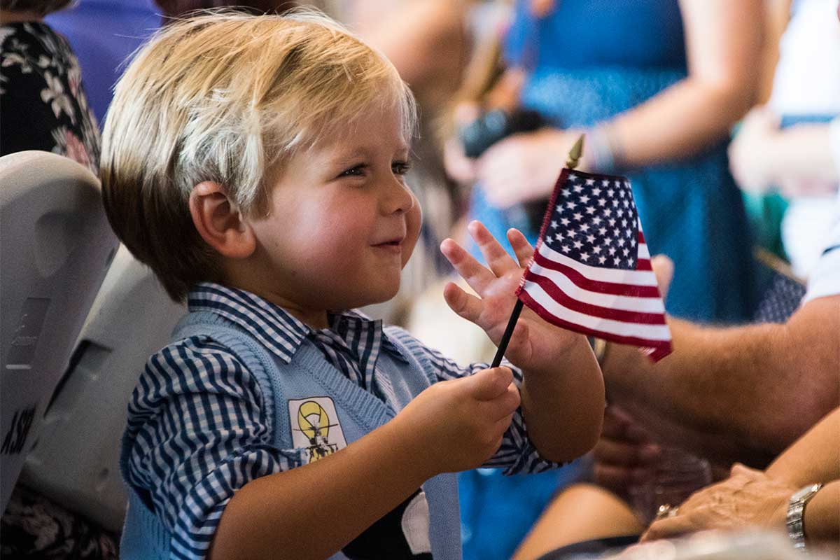 child holding an american flag