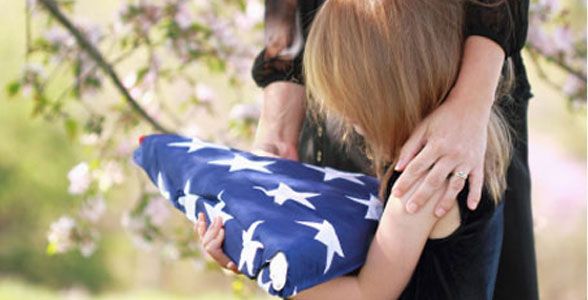young girl holding a folded american flag