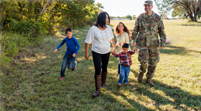 Family of 4 walking holding hands