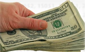 hand holding stack of $50 bills