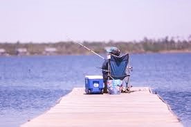 Man fishing from a dock at the lake