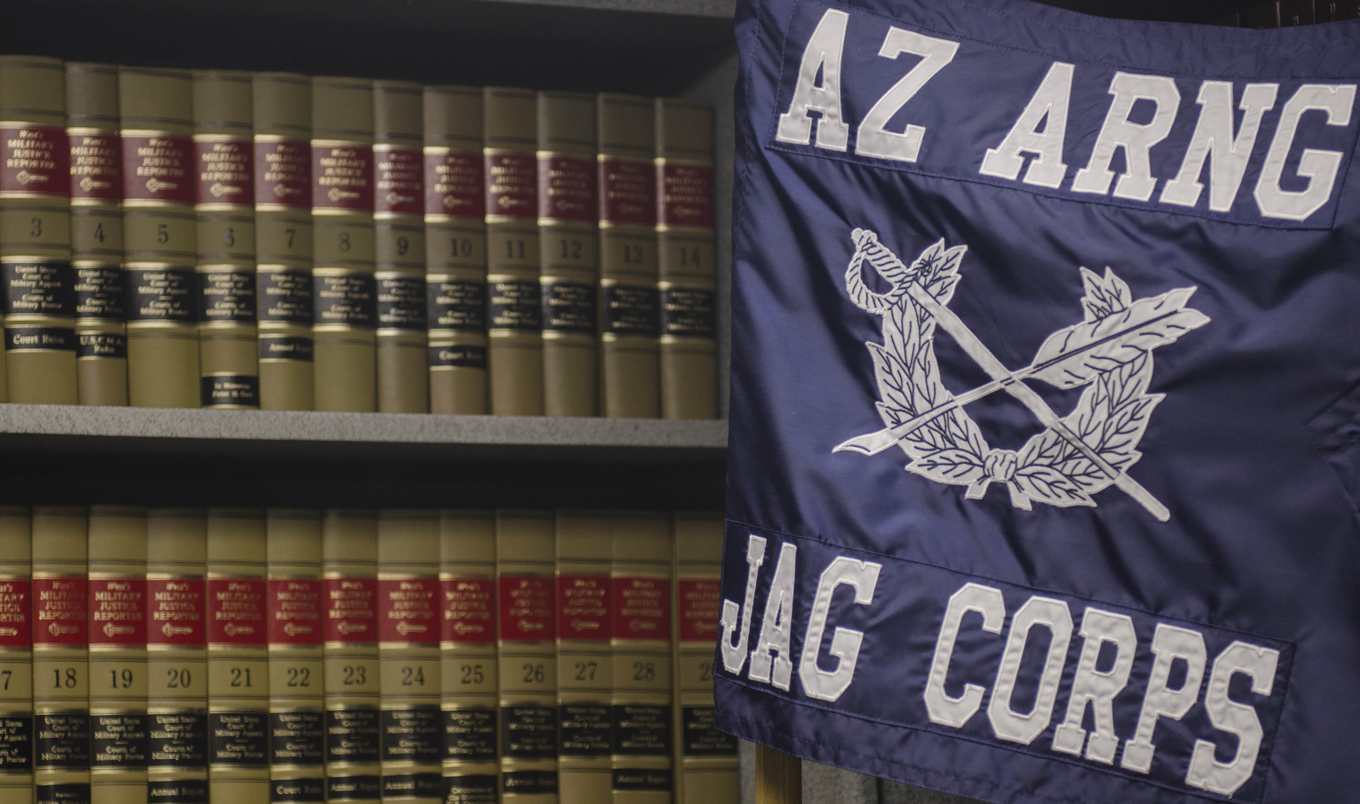 AZ ARNG JAG CORPS flag next to law books