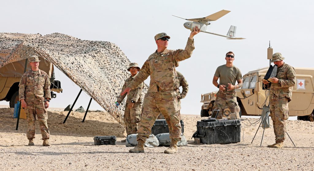 soldiers launching a drone