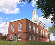 brick building with a flag pole next to it