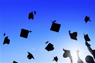 Graduation caps being toss up in the air
