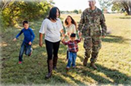 family of 5 walking in a field