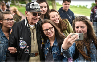 veteran having his picture made with a group of people