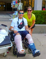 man with both legs in casts in a wheel chair