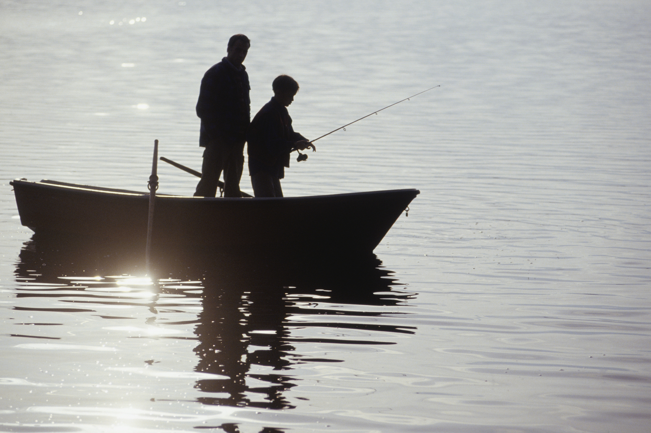 two people in a boat fishing