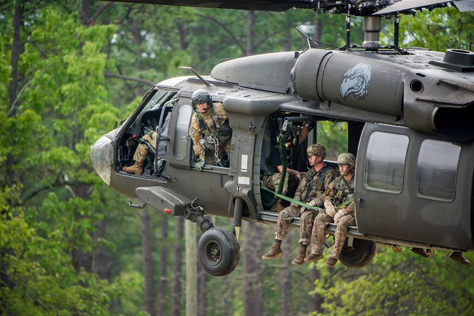soldiers riding in a helicopter