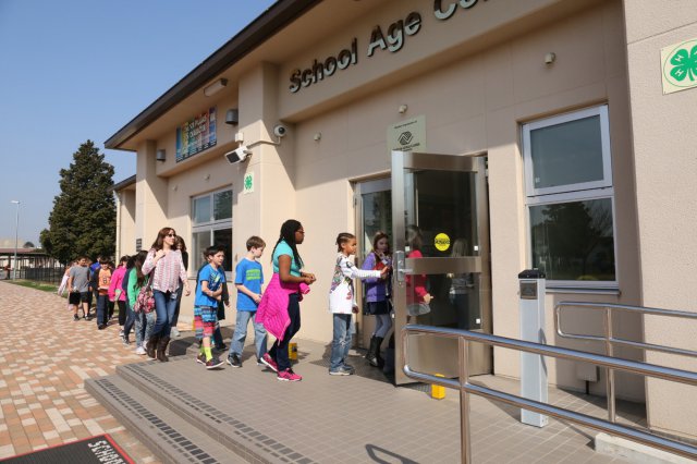 School Age Care Center building with kids waliking in