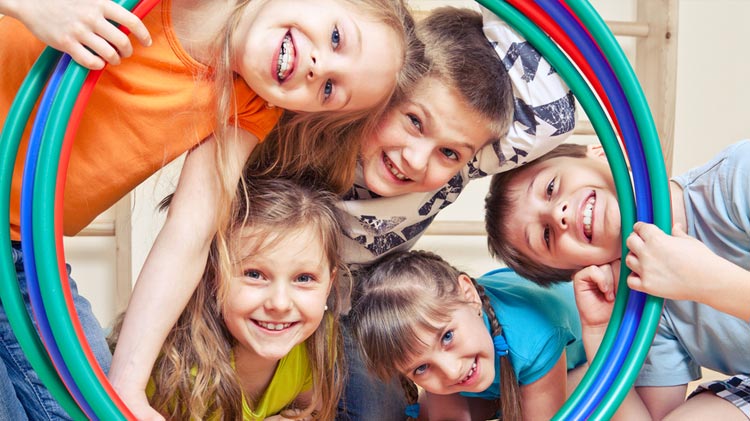 kids looking through a hula hoop