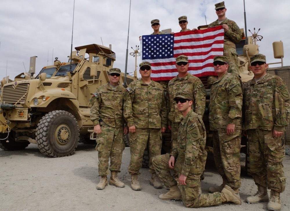 soldiers holding an American Flag