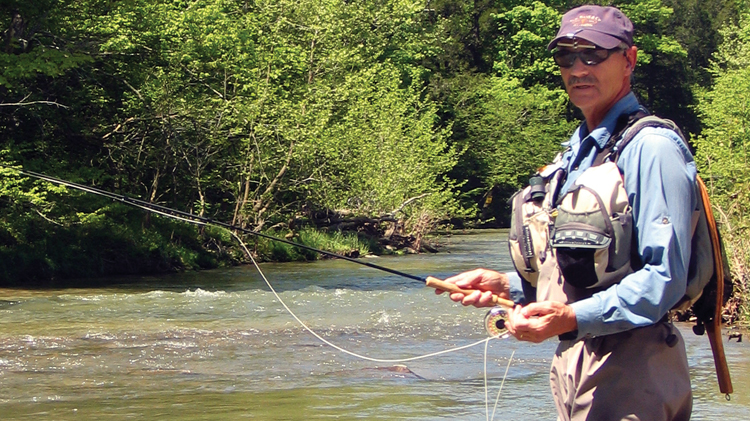 man flyfishing in a stream