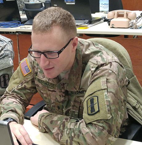 Soldier sitting at a desk