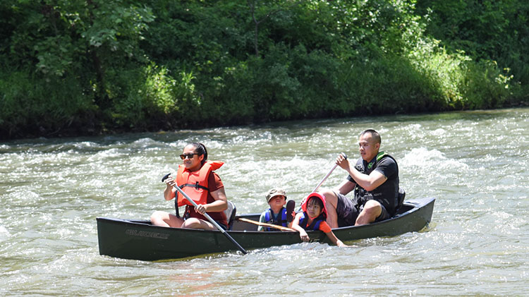 Family Canoeing down a river