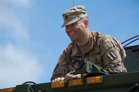 Soldier leaning over the top of a vehicle