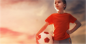 girl holding a soccer ball