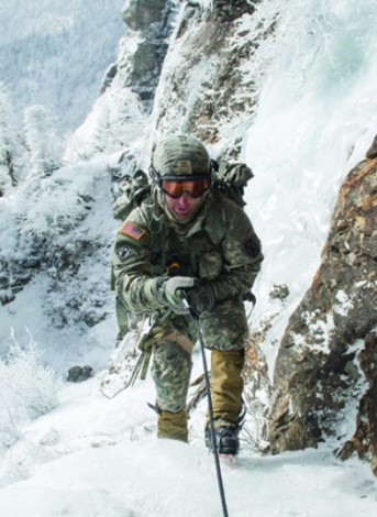 Soldier climbing a mountain in the snow