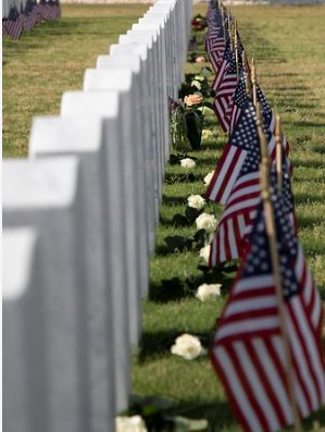 row of veteran tombstones with american flags