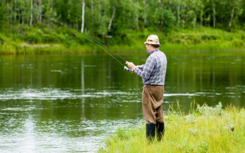 man fishing at a river