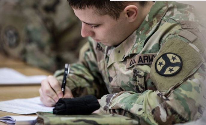 soldier writing on a notepad