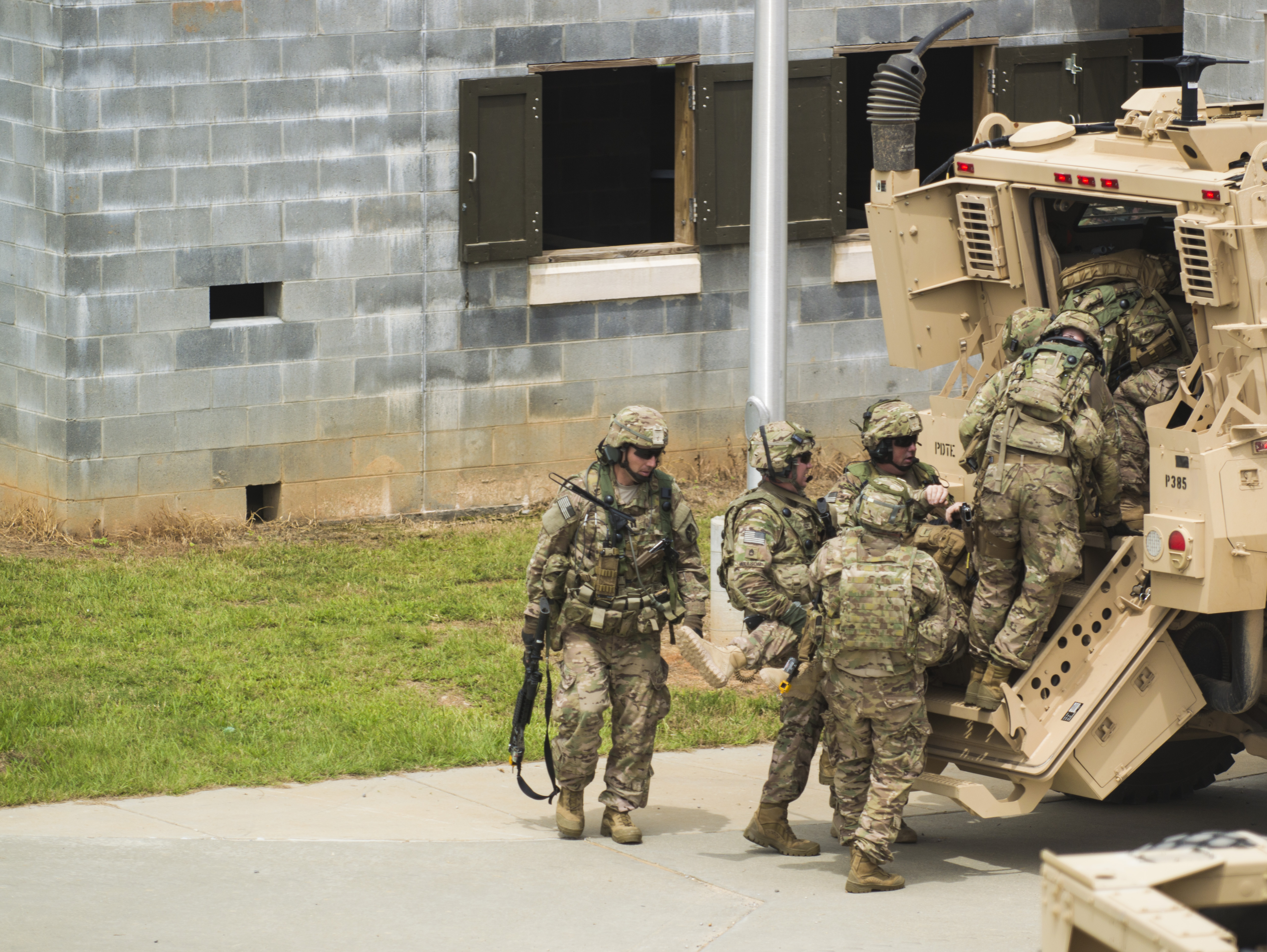 soliders boarding a vehicle