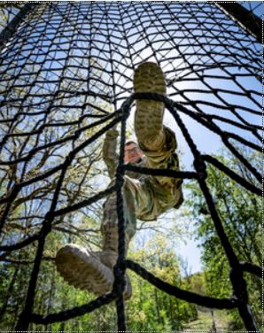 Soldier climbing a cargo net