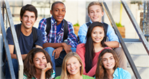Children sitting on the steps of a school